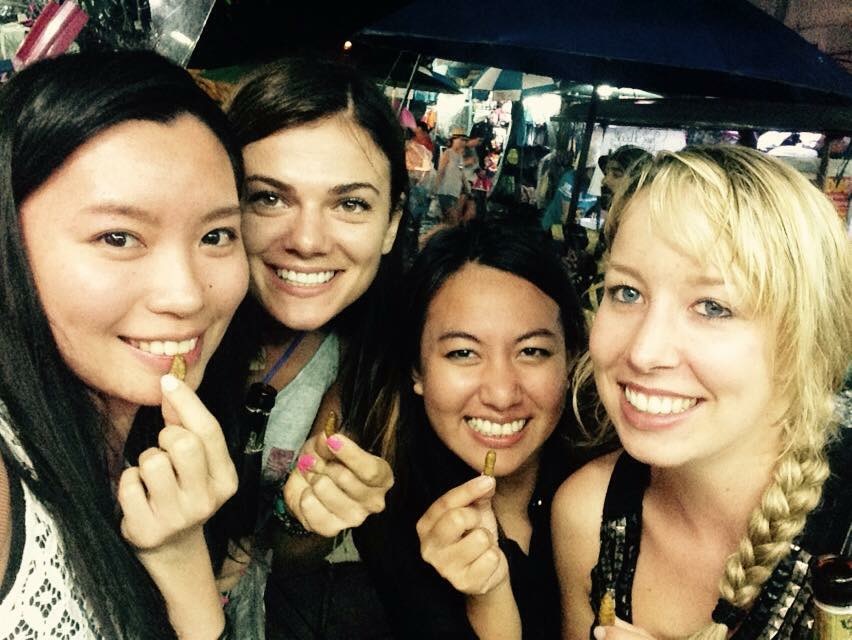 Girls eating bugs on Koh San Road in Bangkok