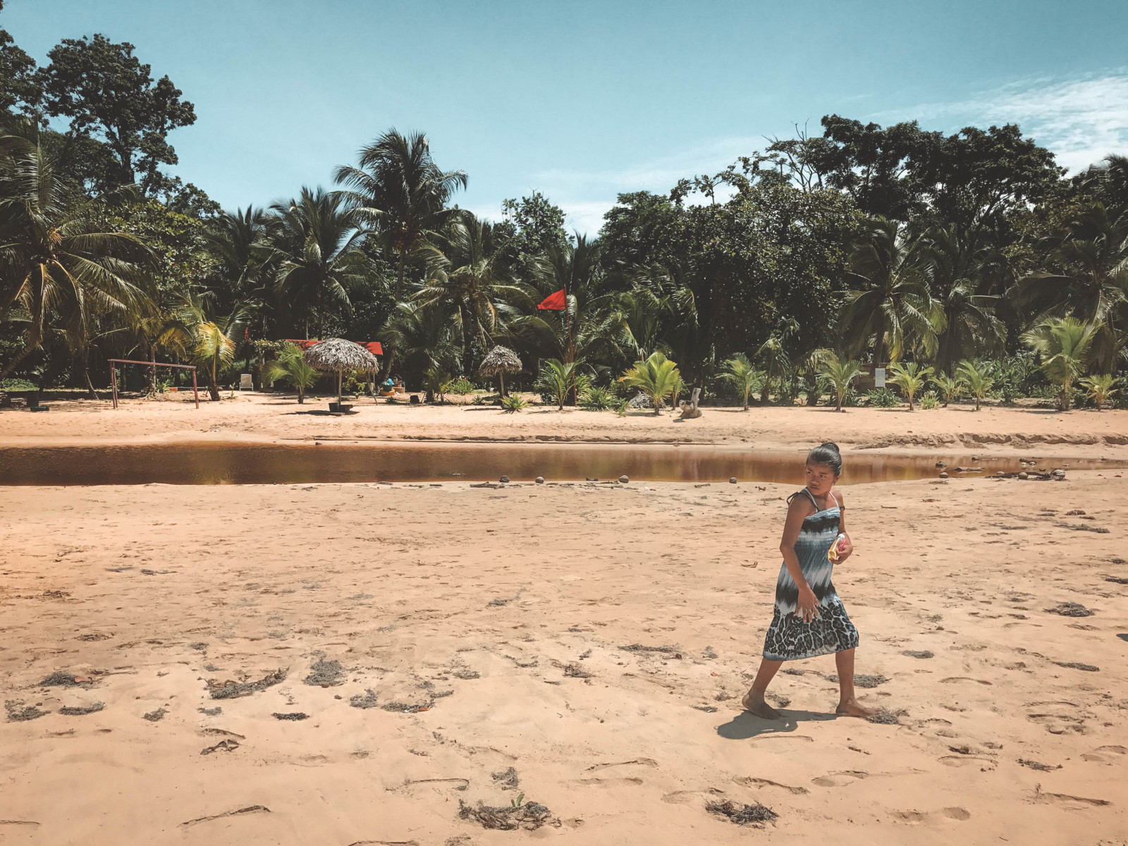 A girl walking on Red Frog beach
